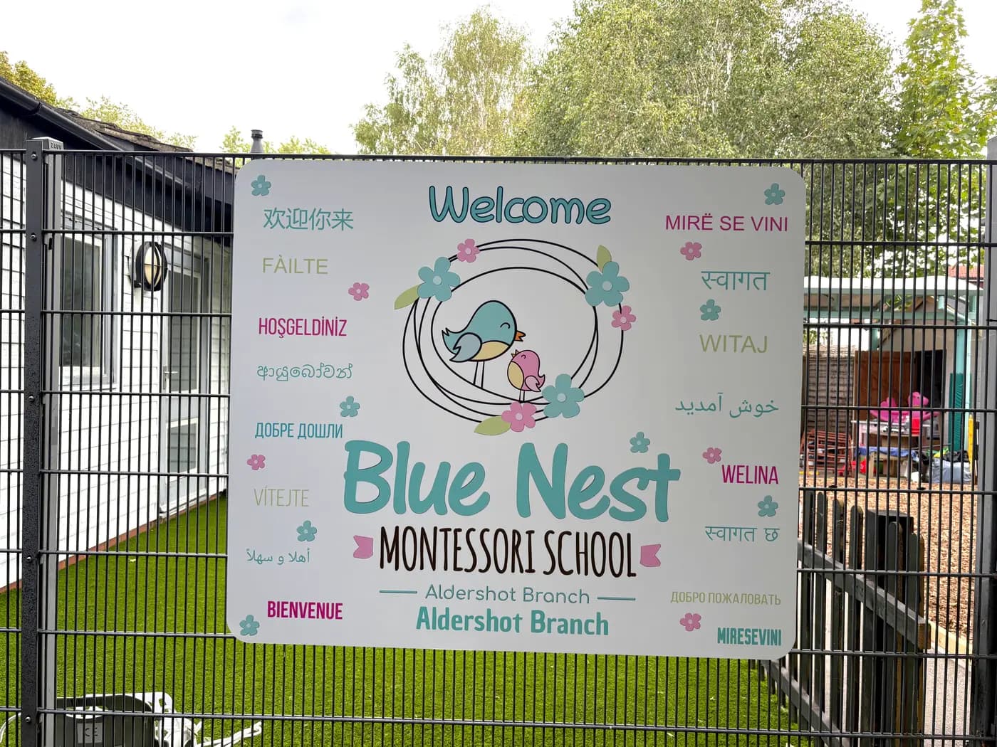 The Aldershot welcome board greeting families in many languages, from Fàilte to Witaj