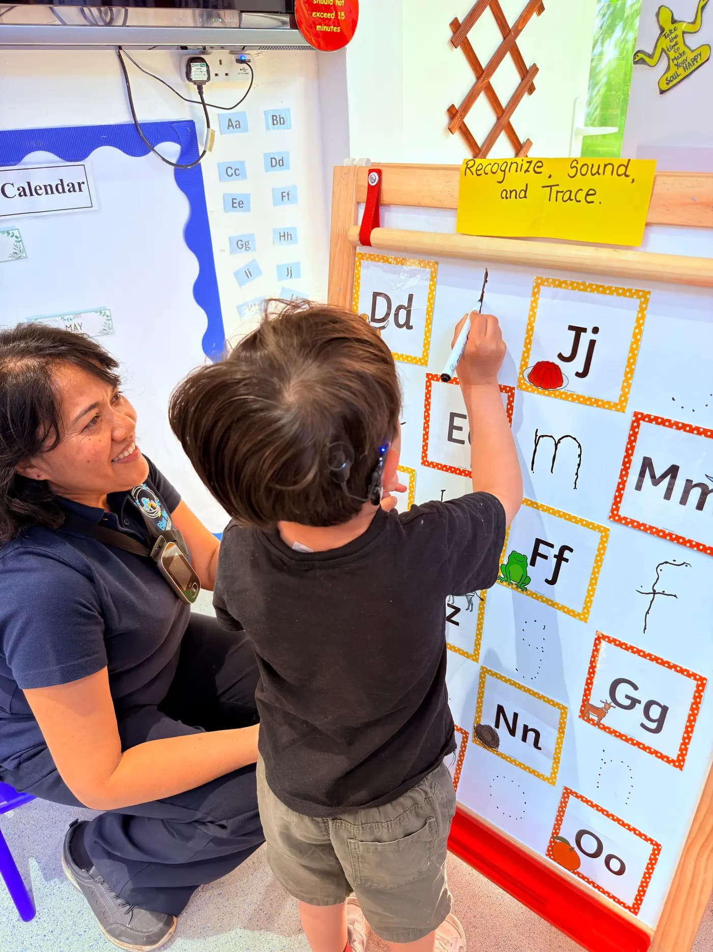Children busy at activity tables across the bright Montessori classroom at Blue Nest Montessori Harrow