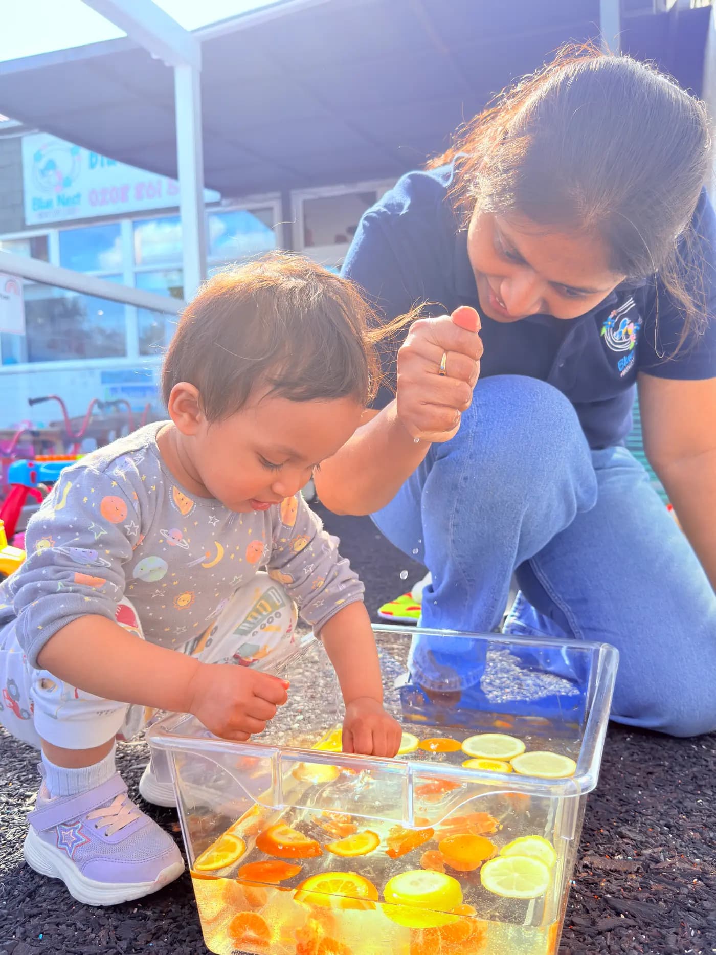 Close-up of a child and educator working on a craft activity at Blue Nest Montessori Harrow