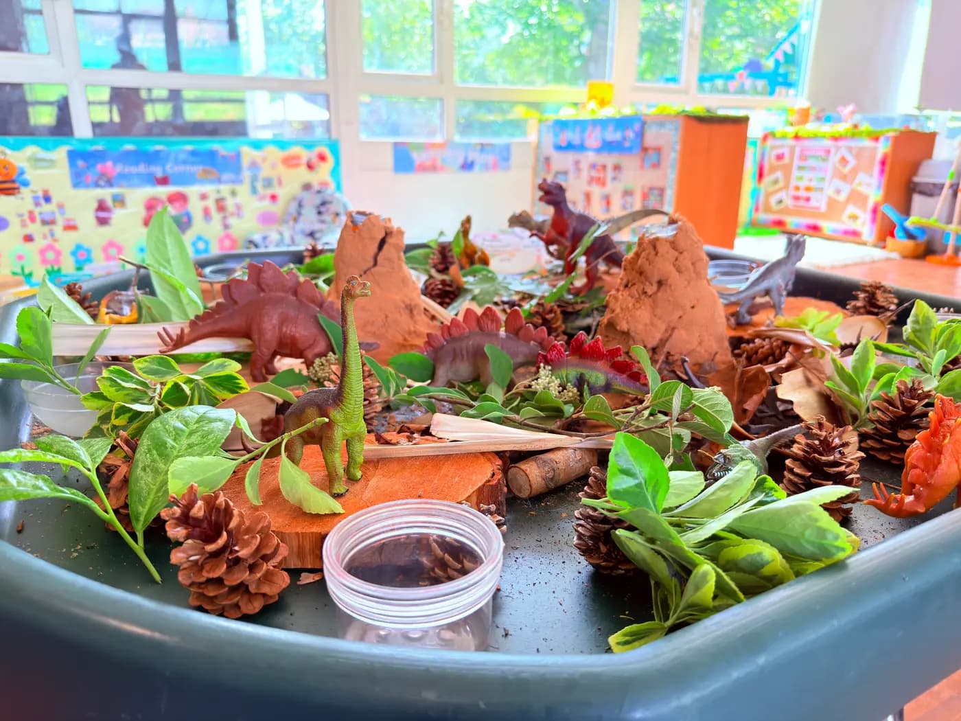 An educator and children at a tabletop snack and craft activity at Blue Nest Pinner