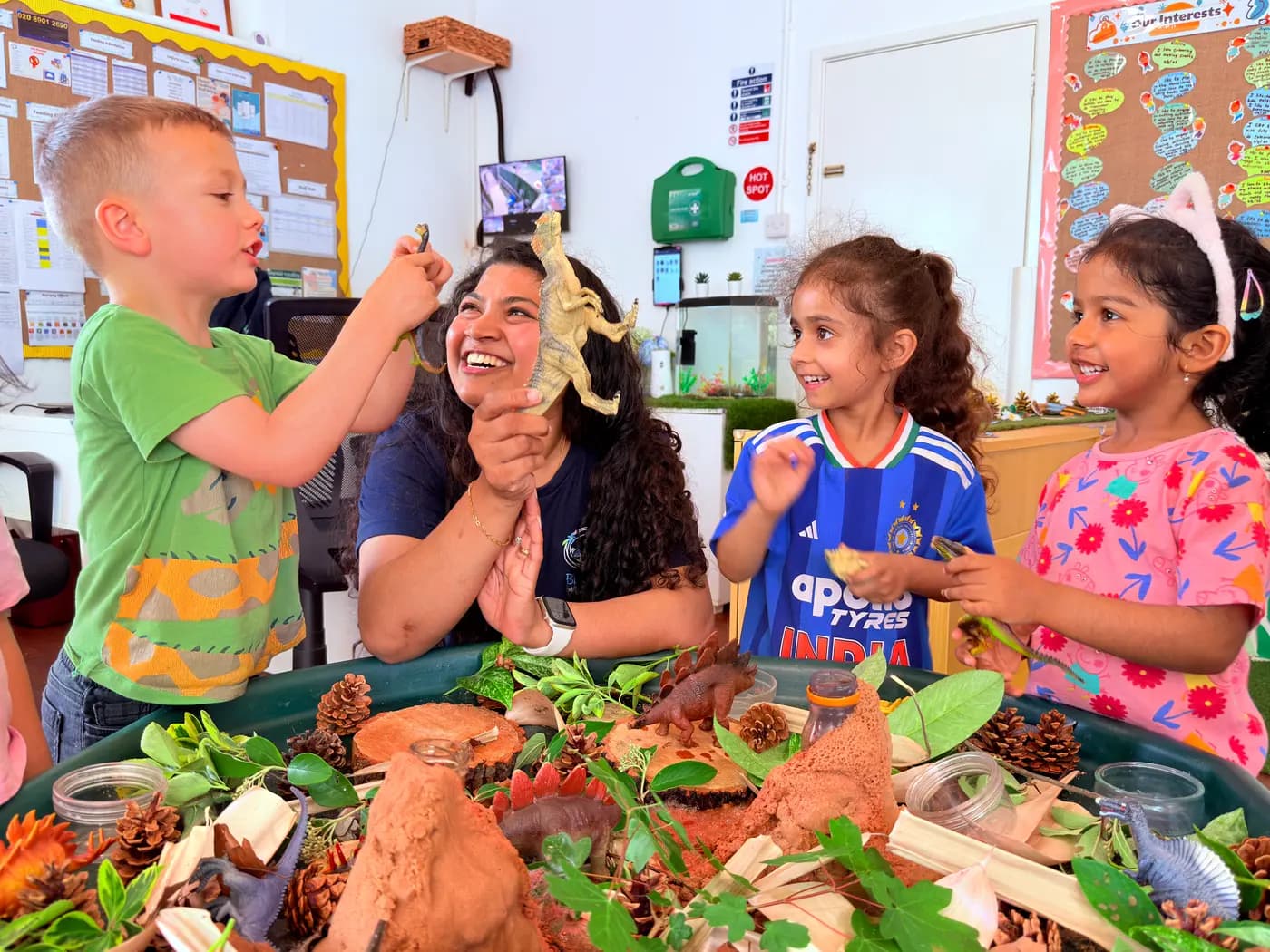 Children exploring a small-world village and animal display in the Blue Nest Pinner garden