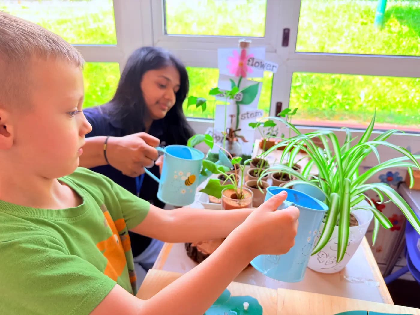 A child working on a tabletop activity with an educator at Blue Nest Pinner