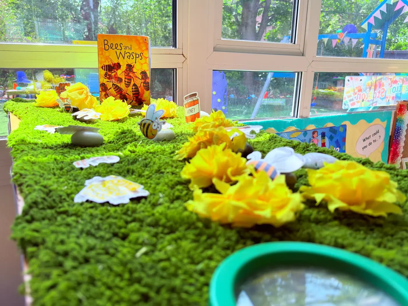 A small-world nature display with plants and toy animals in the Blue Nest Pinner garden